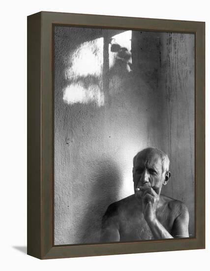 Pablo Picasso, Bare Chested and Smoking Cigarette-Gjon Mili-Framed Premier Image Canvas