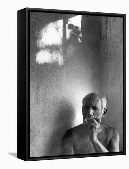 Pablo Picasso, Bare Chested and Smoking Cigarette-Gjon Mili-Framed Premier Image Canvas