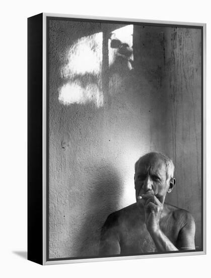 Pablo Picasso, Bare Chested and Smoking Cigarette-Gjon Mili-Framed Premier Image Canvas