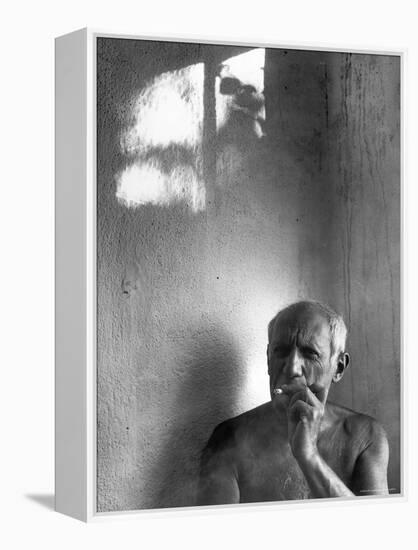 Pablo Picasso, Bare Chested and Smoking Cigarette-Gjon Mili-Framed Premier Image Canvas