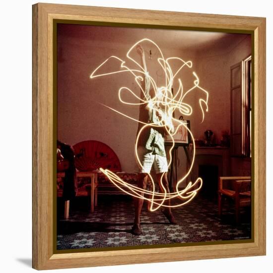 Pablo Picasso Creating Light Drawing of Vase of Flowers, Alone-Gjon Mili-Framed Premier Image Canvas