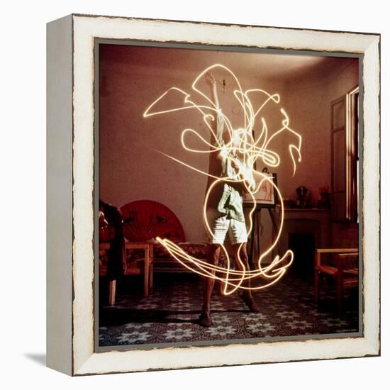 Pablo Picasso Creating Light Drawing of Vase of Flowers, Alone-Gjon Mili-Framed Premier Image Canvas