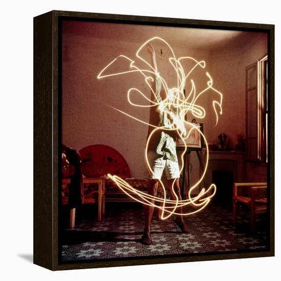 Pablo Picasso Creating Light Drawing of Vase of Flowers, Alone-Gjon Mili-Framed Premier Image Canvas