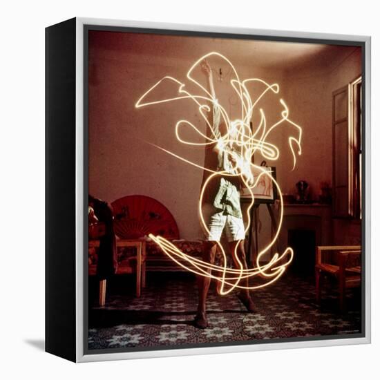 Pablo Picasso Creating Light Drawing of Vase of Flowers, Alone-Gjon Mili-Framed Premier Image Canvas