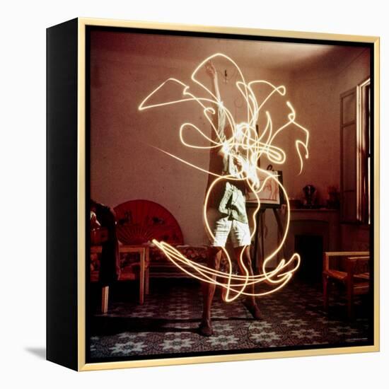 Pablo Picasso Creating Light Drawing of Vase of Flowers, Alone-Gjon Mili-Framed Premier Image Canvas