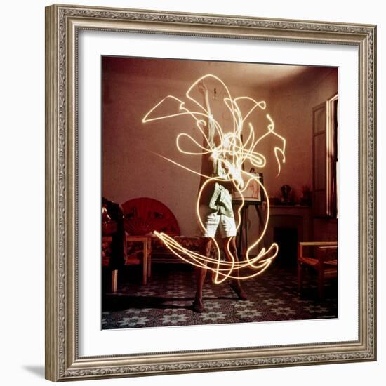 Pablo Picasso Creating Light Drawing of Vase of Flowers, Alone-Gjon Mili-Framed Premium Photographic Print