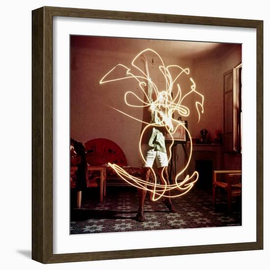 Pablo Picasso Creating Light Drawing of Vase of Flowers, Alone-Gjon Mili-Framed Premium Photographic Print