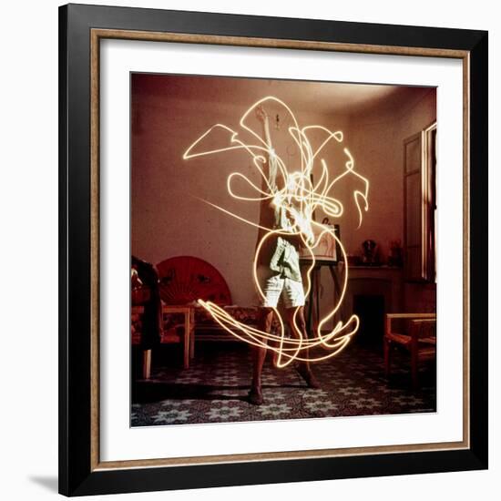 Pablo Picasso Creating Light Drawing of Vase of Flowers, Alone-Gjon Mili-Framed Premium Photographic Print