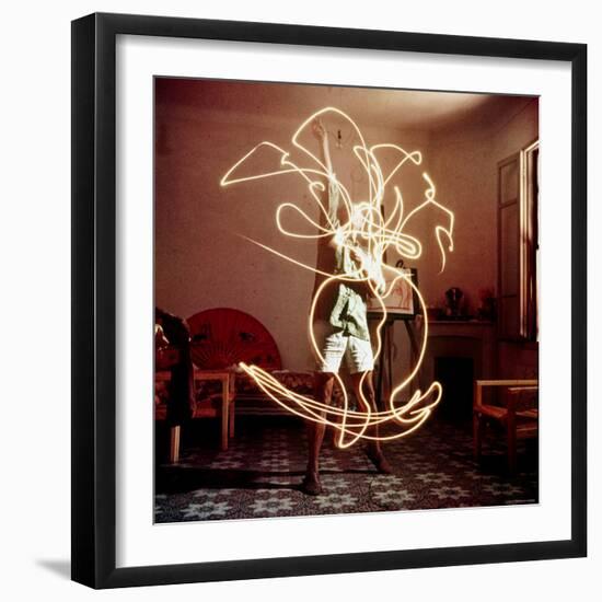 Pablo Picasso Creating Light Drawing of Vase of Flowers, Alone-Gjon Mili-Framed Premium Photographic Print