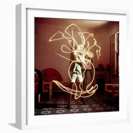 Pablo Picasso Creating Light Drawing of Vase of Flowers, Alone-Gjon Mili-Framed Premium Photographic Print