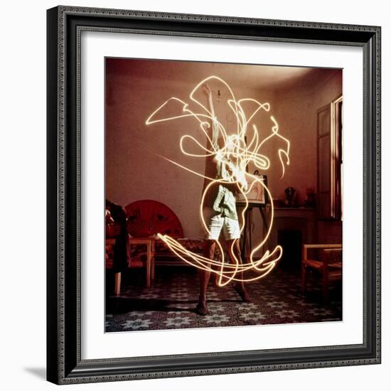 Pablo Picasso Creating Light Drawing of Vase of Flowers, Alone-Gjon Mili-Framed Premium Photographic Print
