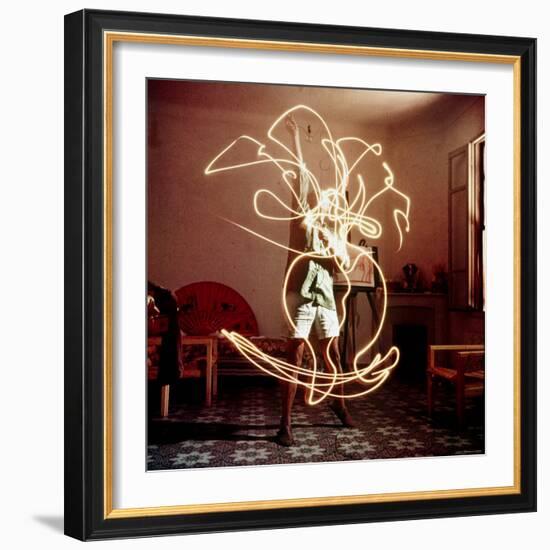 Pablo Picasso Creating Light Drawing of Vase of Flowers, Alone-Gjon Mili-Framed Premium Photographic Print