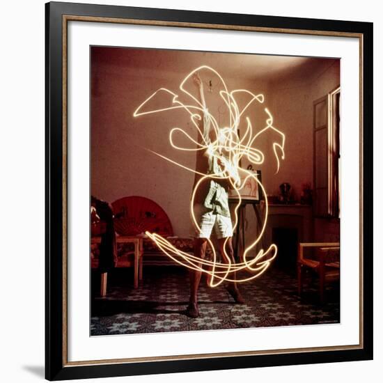 Pablo Picasso Creating Light Drawing of Vase of Flowers, Alone-Gjon Mili-Framed Premium Photographic Print