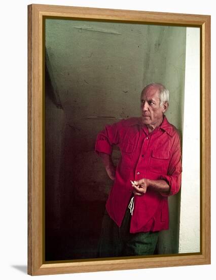 Pablo Picasso Leaning Against Wall and Holding Smoldering Cigarette-Gjon Mili-Framed Premier Image Canvas