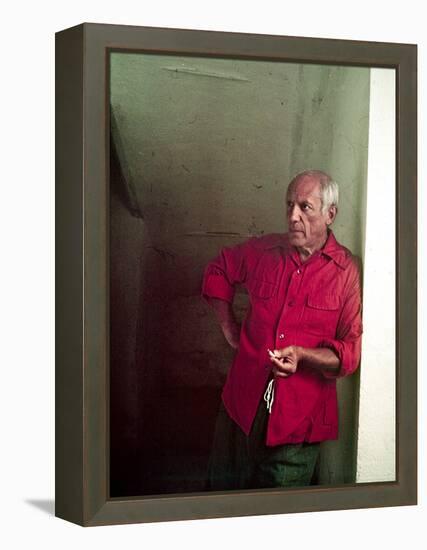 Pablo Picasso Leaning Against Wall and Holding Smoldering Cigarette-Gjon Mili-Framed Premier Image Canvas