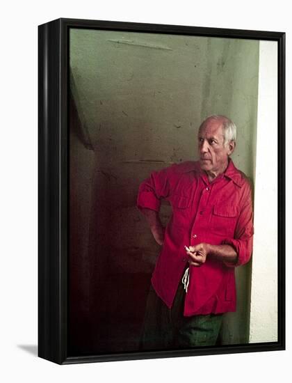 Pablo Picasso Leaning Against Wall and Holding Smoldering Cigarette-Gjon Mili-Framed Premier Image Canvas