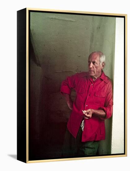 Pablo Picasso Leaning Against Wall and Holding Smoldering Cigarette-Gjon Mili-Framed Premier Image Canvas