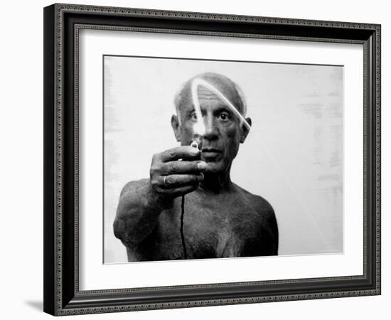 Pablo Picasso Using Flashlight to Begin Making Light Drawing in the Air-Gjon Mili-Framed Premium Photographic Print