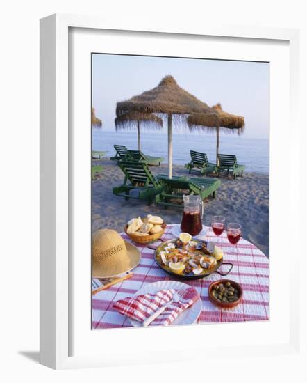 Paella with Olives, Bread and Sangria on a Table on the Beach in Andalucia, Spain-Michael Busselle-Framed Photographic Print