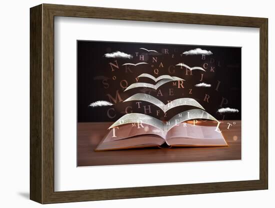 Pages and Glowing Letters Flying out of a Book on Wooden Deck-ra2studio-Framed Photographic Print