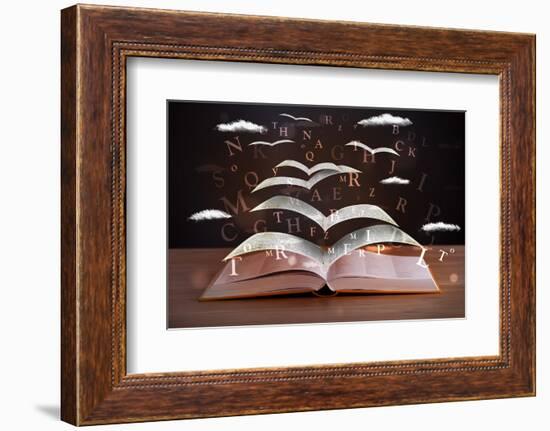 Pages and Glowing Letters Flying out of a Book on Wooden Deck-ra2studio-Framed Photographic Print