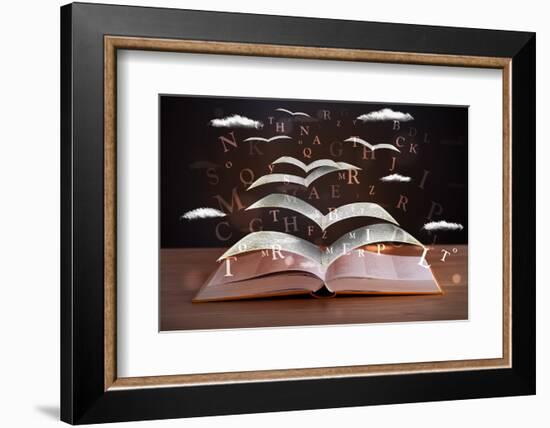 Pages and Glowing Letters Flying out of a Book on Wooden Deck-ra2studio-Framed Photographic Print