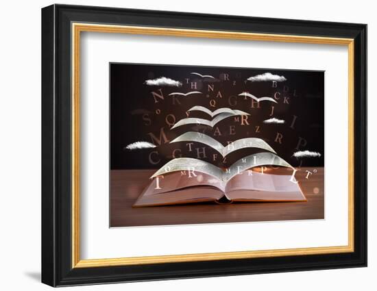 Pages and Glowing Letters Flying out of a Book on Wooden Deck-ra2studio-Framed Photographic Print