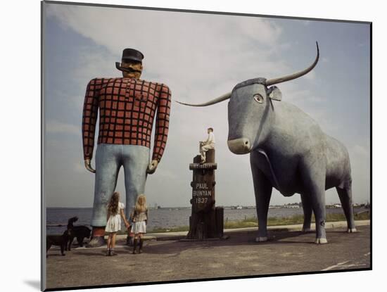 Painted Concrete Sculpture of Paul Bunyon and His Blue Ox, Babe Standing on Shores of Lake Bemidji-Andreas Feininger-Mounted Photographic Print