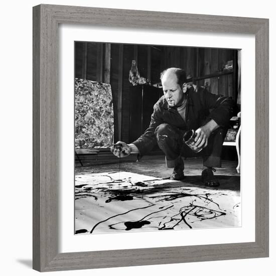 Painter Jackson Pollock Working in His Studio, Cigarette in Mouth, Dropping Paint Onto Canvas-Martha Holmes-Framed Photographic Print