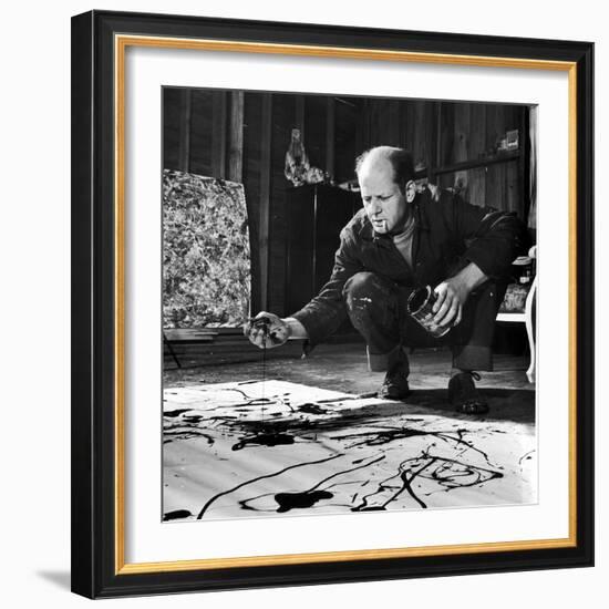 Painter Jackson Pollock Working in His Studio, Cigarette in Mouth, Dropping Paint Onto Canvas-Martha Holmes-Framed Photographic Print