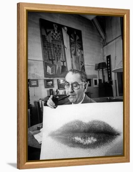 Painter Photographer Man Ray Holding Up "Lips" Print, Winking at Camera and Smoking a Pipe-Loomis Dean-Framed Premier Image Canvas