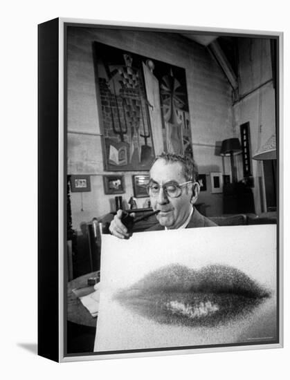 Painter Photographer Man Ray Holding Up "Lips" Print, Winking at Camera and Smoking a Pipe-Loomis Dean-Framed Premier Image Canvas