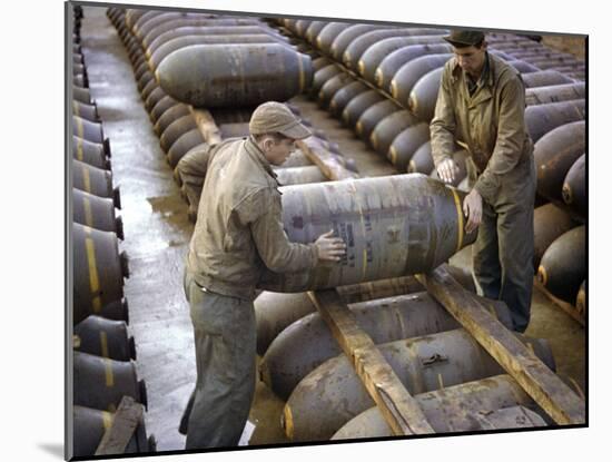 Pair of American Servicemen Moving a Large Bomb at an Ammunition Dump During WWII-null-Mounted Photographic Print