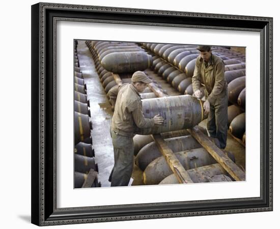 Pair of American Servicemen Moving a Large Bomb at an Ammunition Dump During WWII-null-Framed Photographic Print