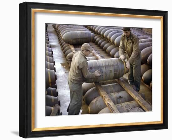 Pair of American Servicemen Moving a Large Bomb at an Ammunition Dump During WWII-null-Framed Photographic Print