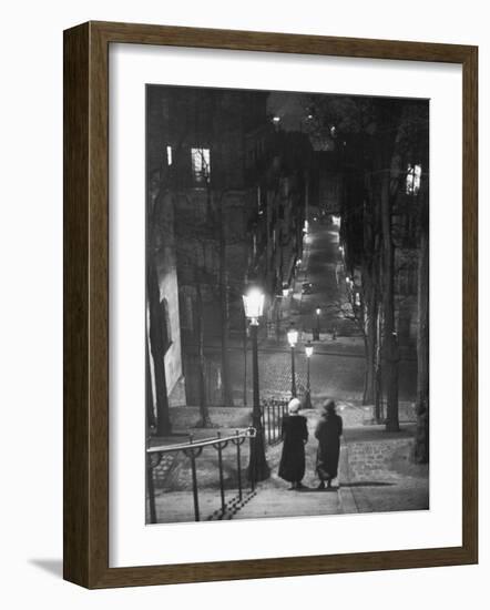 Pair of Prostitutes Descending Stairs after Dark in Montmartre-Alfred Eisenstaedt-Framed Photographic Print