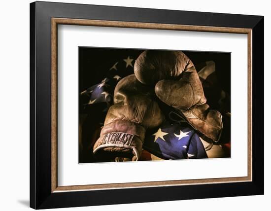 Pair of vintage boxing gloves laying on a flag carefully painted with light-Sheila Haddad-Framed Photographic Print