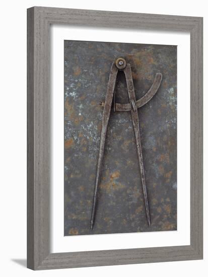 Pair of Vintage Tarnished Measuring Dividers Or Compasses Lying On Rusty Metal Sheet-Den Reader-Framed Photographic Print