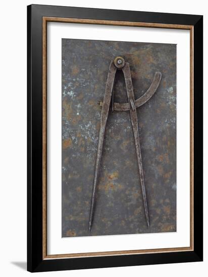 Pair of Vintage Tarnished Measuring Dividers Or Compasses Lying On Rusty Metal Sheet-Den Reader-Framed Photographic Print