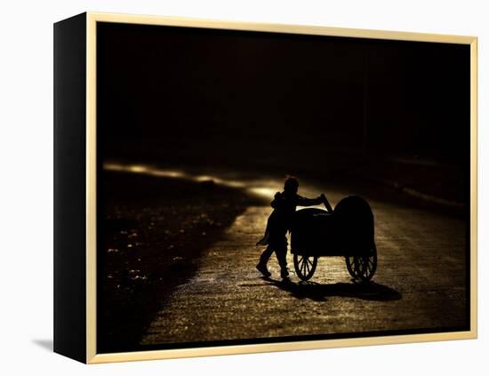 Pakistani Boy Pushes a Cart Along the Main Street in Rawalpindi, Pakistan-null-Framed Premier Image Canvas