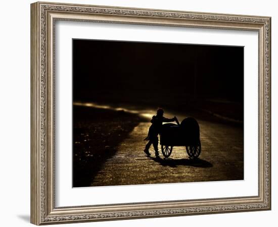 Pakistani Boy Pushes a Cart Along the Main Street in Rawalpindi, Pakistan-null-Framed Photographic Print