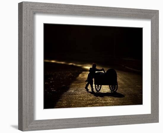 Pakistani Boy Pushes a Cart Along the Main Street in Rawalpindi, Pakistan-null-Framed Photographic Print