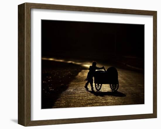 Pakistani Boy Pushes a Cart Along the Main Street in Rawalpindi, Pakistan-null-Framed Photographic Print