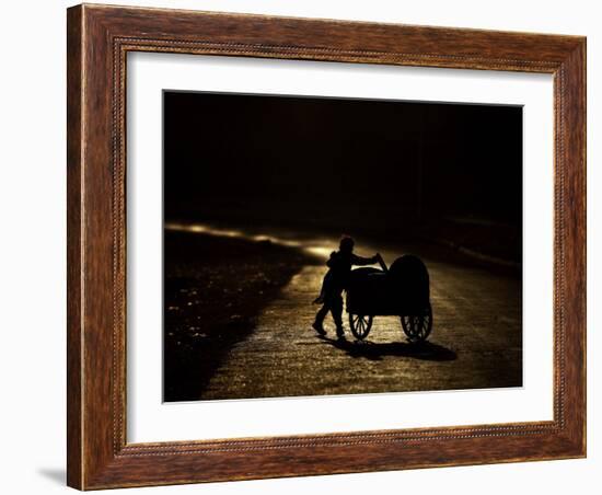 Pakistani Boy Pushes a Cart Along the Main Street in Rawalpindi, Pakistan-null-Framed Photographic Print