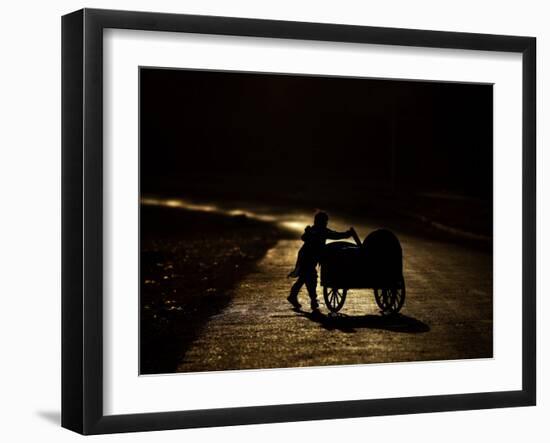 Pakistani Boy Pushes a Cart Along the Main Street in Rawalpindi, Pakistan-null-Framed Photographic Print