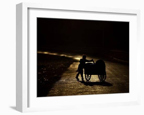 Pakistani Boy Pushes a Cart Along the Main Street in Rawalpindi, Pakistan-null-Framed Photographic Print