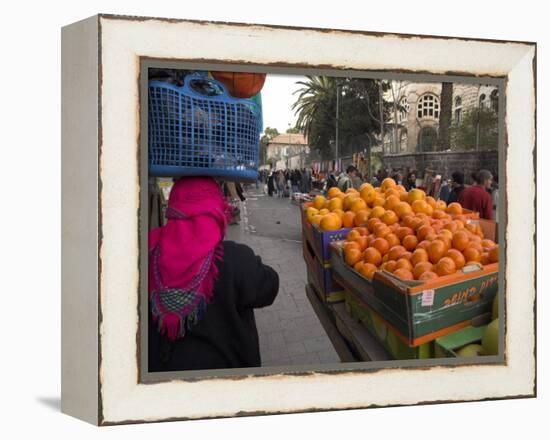 Palestinian Woman in Colourful Scarf and Carrying Bag on Her Head Walking Past an Orange Stall-Eitan Simanor-Framed Premier Image Canvas