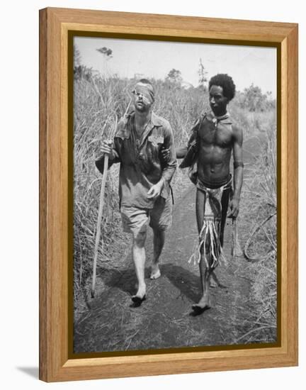 Papuan Native Helping a Wounded Australian Infantryman Along Road Away from the Buna Battlefront-George Silk-Framed Premier Image Canvas