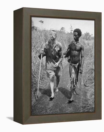 Papuan Native Helping a Wounded Australian Infantryman Along Road Away from the Buna Battlefront-George Silk-Framed Premier Image Canvas