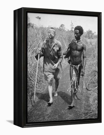 Papuan Native Helping a Wounded Australian Infantryman Along Road Away from the Buna Battlefront-George Silk-Framed Premier Image Canvas